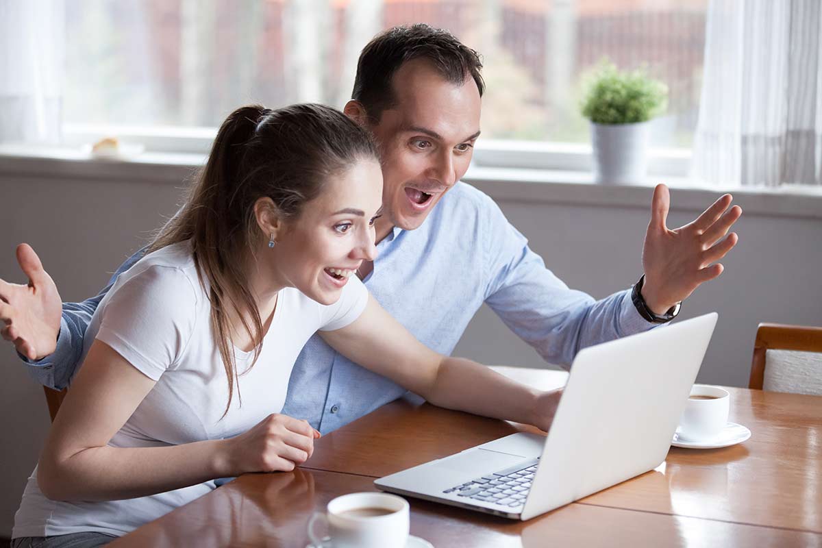 young couple looking at a laptop